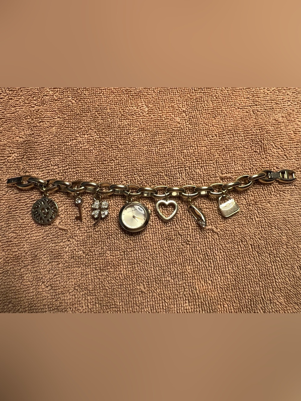 Anne Klein Women’s Crystal Accented Gold Tone Charm Bracelet Watch